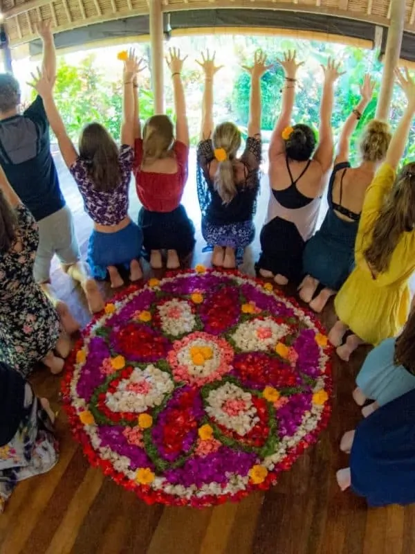 Yoga teacher training students doin fire toes aroung a mandala