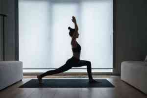 woman performming high crescent lunge position at home